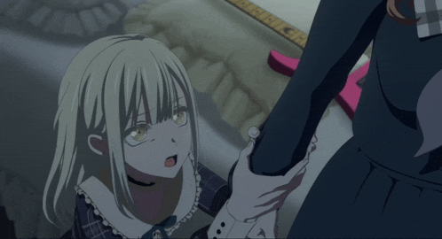 a girl with blonde hair is holding another girl 's arm