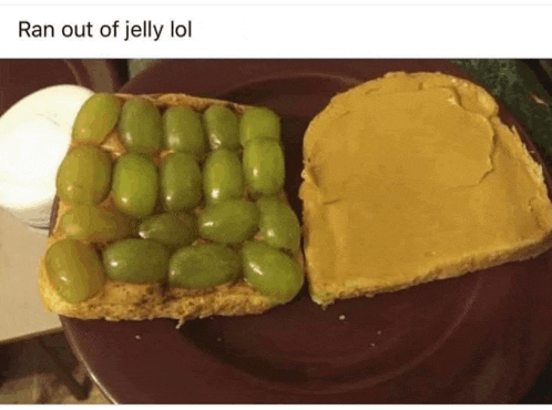 a sandwich with peanut butter and grapes on a plate