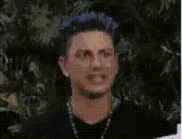 a man is blowing a bubble with a light coming out of his mouth .