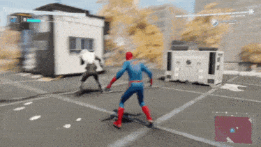 a man in a spiderman costume is playing a video game .