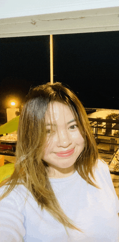 a woman taking a selfie with her hair covering her face