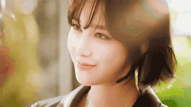 a close up of a woman 's face with the sun shining through her eyes .