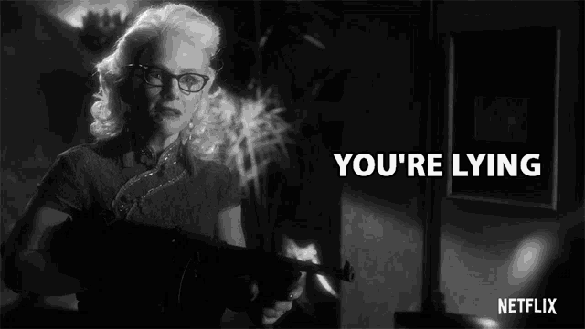 a black and white photo of a woman holding a gun with the words " you 're lying " below her