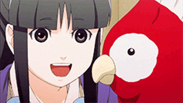 a girl is smiling while holding a red stuffed animal