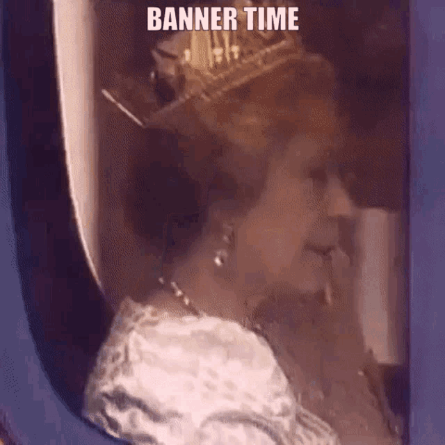 queen elizabeth ii is wearing a crown and earrings and looking out of a window .