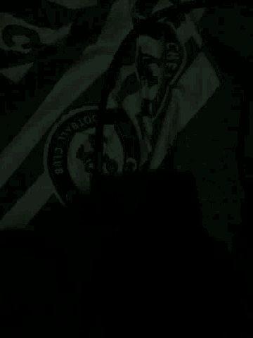 a close up of a chelsea fc jersey in the dark .