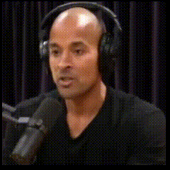 a man wearing headphones and giving a thumbs up