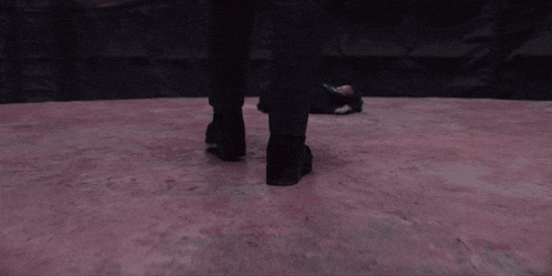 a person 's feet are shown on a pink floor
