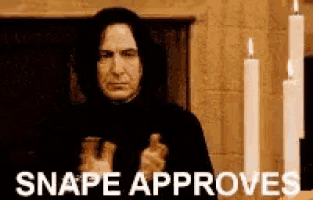 snape approves a man holding a bottle in front of candles