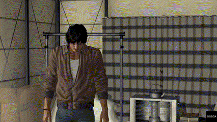 a man in a brown jacket is standing in a room with a plaid curtain behind him .