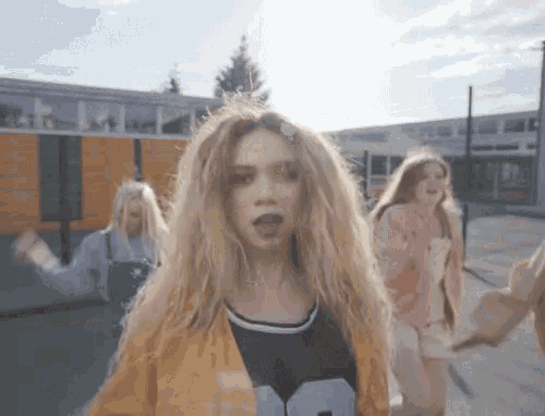 a girl with blonde hair wearing a shirt with the number 9 on it