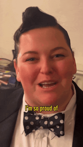 a man wearing a bow tie and a suit says " i 'm so proud of "