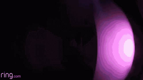 a close up of a purple light in the dark
