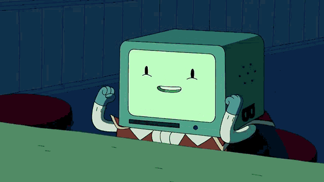 a cartoon character with a green box on his head is sitting at a table with his fist in the air