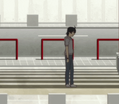 a man is standing on a crosswalk with a red barrier in the background