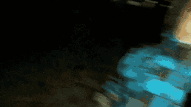 a blurry picture of a person wearing a blue sweater
