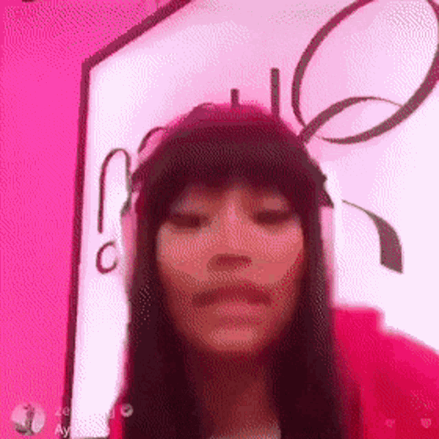 a woman with long black hair is wearing a pink headband .