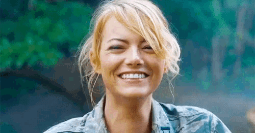 a close up of a woman 's face smiling with a blurred background .