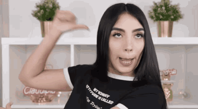 a woman wearing a shirt that says " my mommy attitude is called "