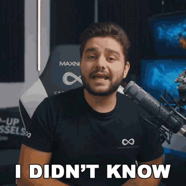a man sitting in front of a microphone with the words i did n't know on the bottom