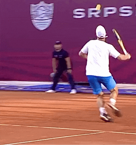 a man playing tennis in front of a sign that says srps