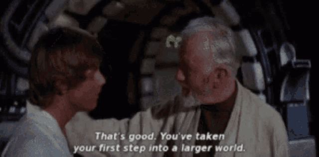 a man with a beard talks to a younger man in a star wars movie .