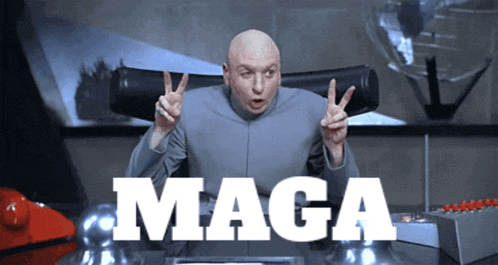 a bald man is giving a peace sign in front of a sign that says maga