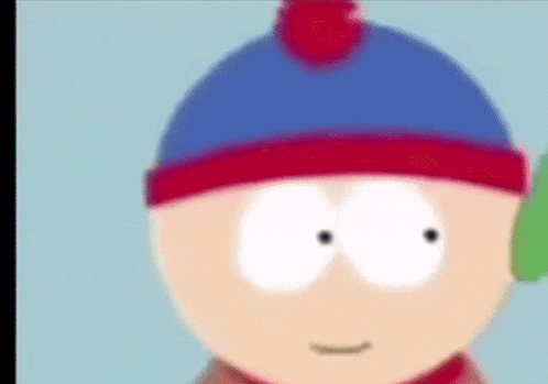 a close up of stan from south park wearing a blue hat and red scarf .
