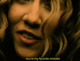 a close up of a woman 's face with the words " you 're my favorite mistake " visible