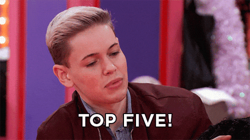 a young man in a brown jacket says " top five "