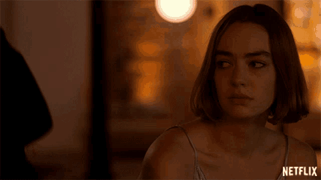 a woman is crying in front of a netflix ad