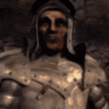a statue of a man in armor with a helmet on his head .