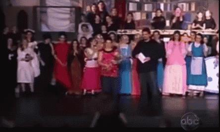a group of people standing on a stage with abc written on the bottom