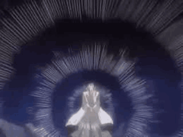 a person is standing in a dark room with their hands folded in front of them .