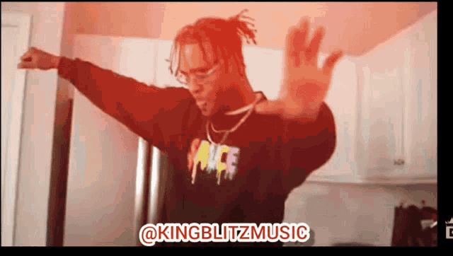 a man wearing a black palace sweatshirt is dancing