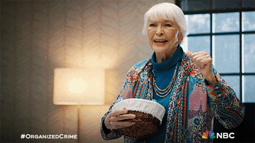 an older woman is holding a basket and smiling with the nbc logo in the corner