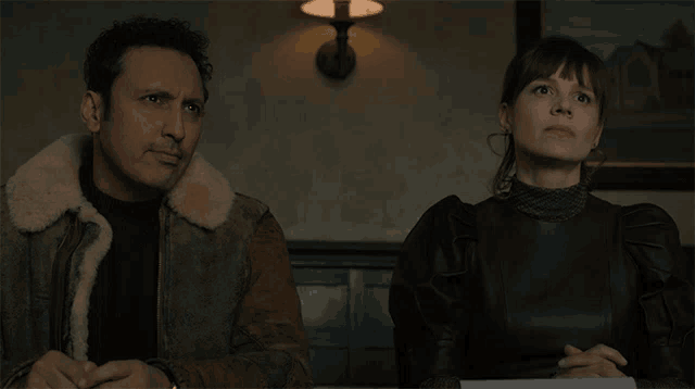 a man and a woman are sitting at a table