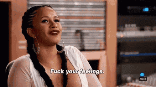 a woman is sitting in a chair and saying fuck your feelings