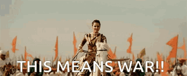 a large group of people on horses in a field with the words " this means war " below them