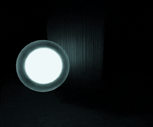 a black and white photo of a light coming out of a hole