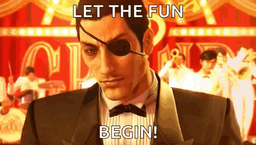 a man in a suit and bow tie with an eye patch on his eye is standing in front of a stage .