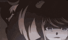 a girl in a maid outfit is crying and smiling in a dark room .