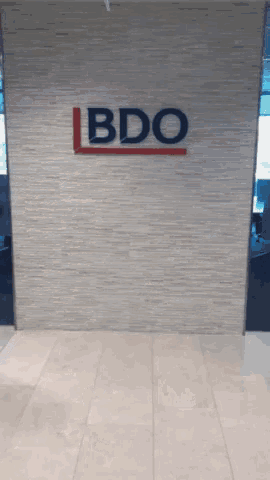 a sign on a wall that says bdo in red and white