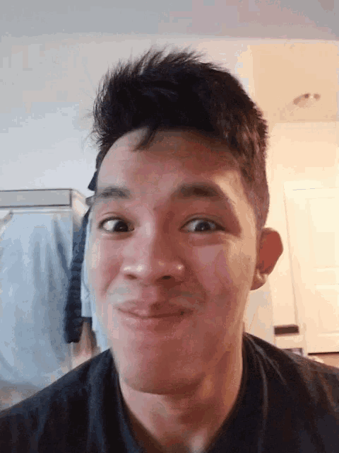 a man making a funny face with his eyes closed and his mouth open