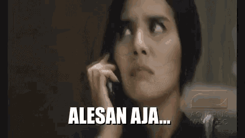 a woman is talking on a cell phone and making a funny face while looking up .