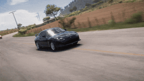 a car is driving down a road with a fence in the background