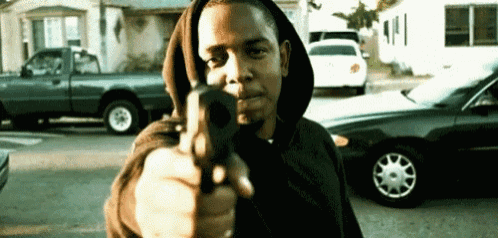 a man in a hooded sweatshirt is pointing a gun
