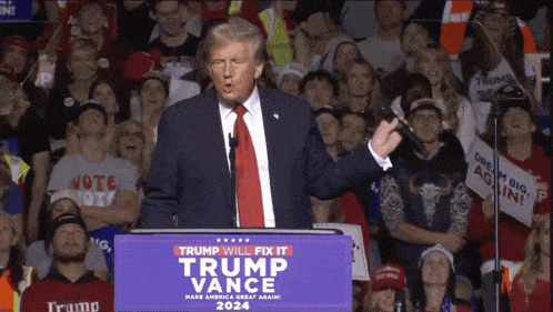 a man stands at a podium that says trump will fix it trump vance 2024