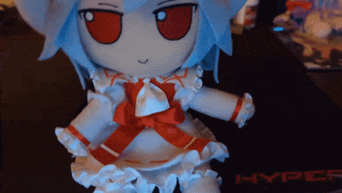 a stuffed doll is sitting on a hyper gaming mouse pad