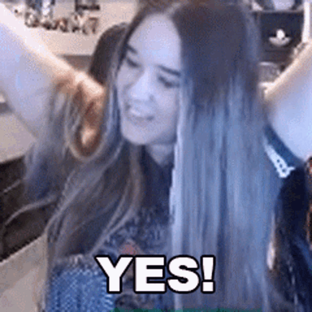 a woman with long hair is saying yes in a video